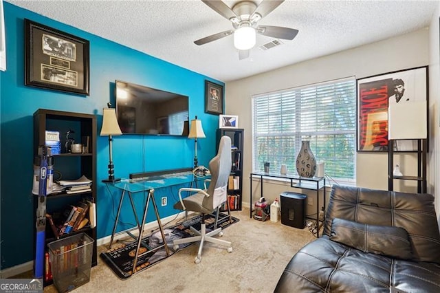 office space featuring ceiling fan, carpet floors, and a textured ceiling