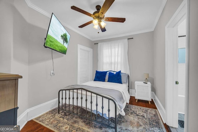 bedroom featuring ceiling fan, dark hardwood / wood-style flooring, and ornamental molding