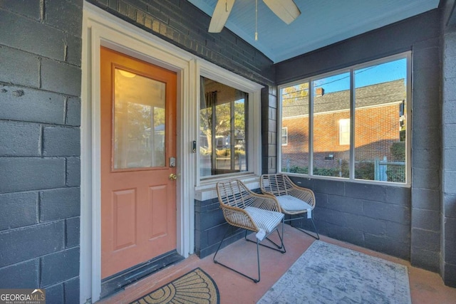 doorway to property with ceiling fan and a porch