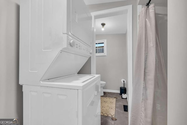 clothes washing area featuring stacked washing maching and dryer and light tile patterned flooring