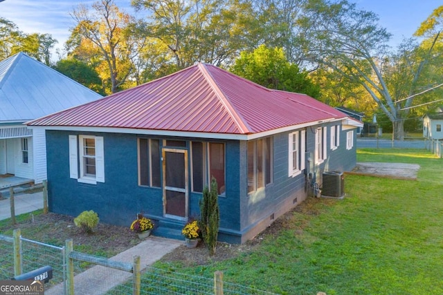 view of property exterior featuring a yard and central AC