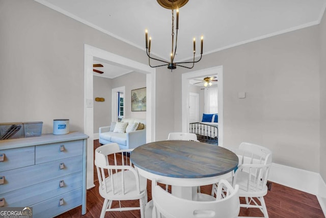 dining area featuring ceiling fan with notable chandelier, dark hardwood / wood-style flooring, and ornamental molding