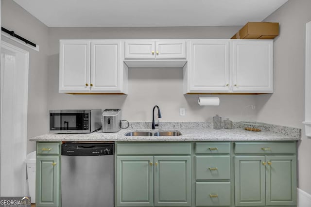 kitchen with white cabinets, light stone counters, sink, and stainless steel appliances