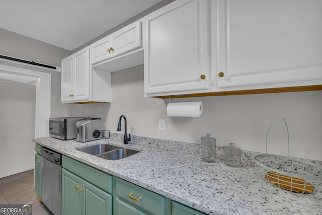 kitchen with stainless steel appliances, sink, light tile patterned floors, white cabinetry, and green cabinets