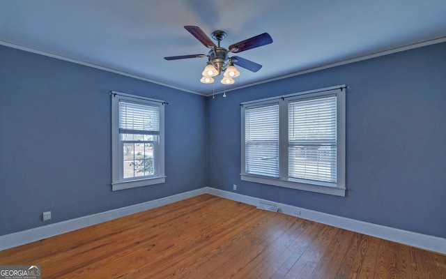 unfurnished room featuring hardwood / wood-style floors, ornamental molding, and ceiling fan