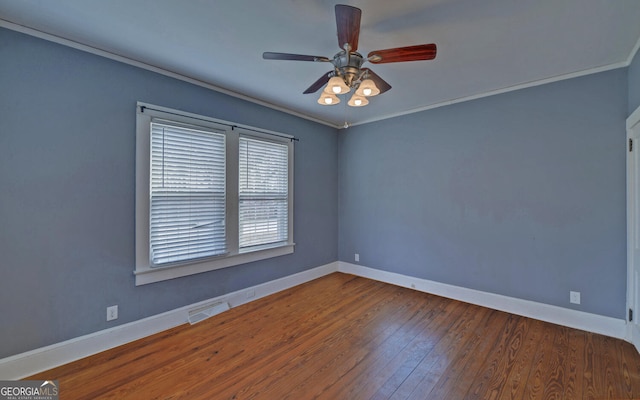 spare room with dark wood-type flooring, ceiling fan, and ornamental molding