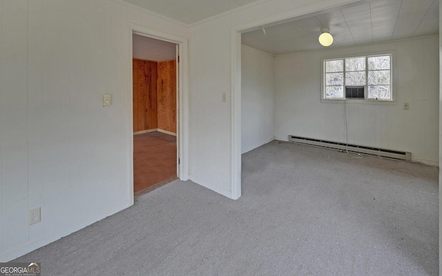 spare room with baseboard heating and crown molding