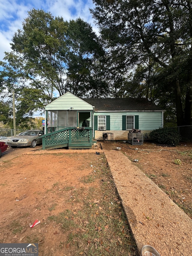 view of front of home featuring a sunroom