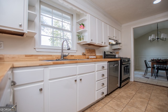 kitchen featuring appliances with stainless steel finishes, sink, pendant lighting, a chandelier, and white cabinetry