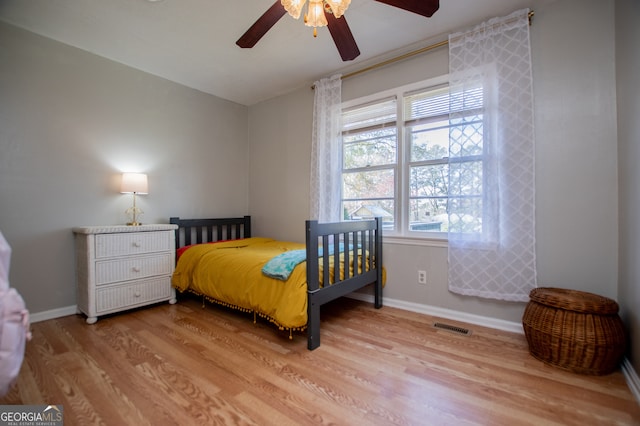 bedroom featuring light wood-type flooring and ceiling fan