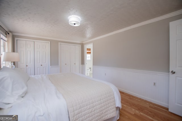 bedroom with ornamental molding, a textured ceiling, and hardwood / wood-style flooring