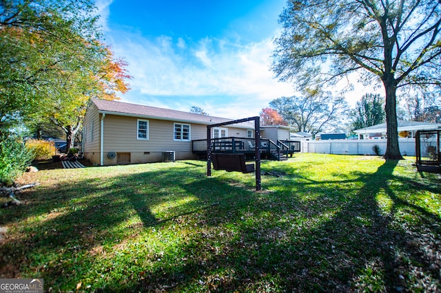 view of yard featuring central AC and a deck