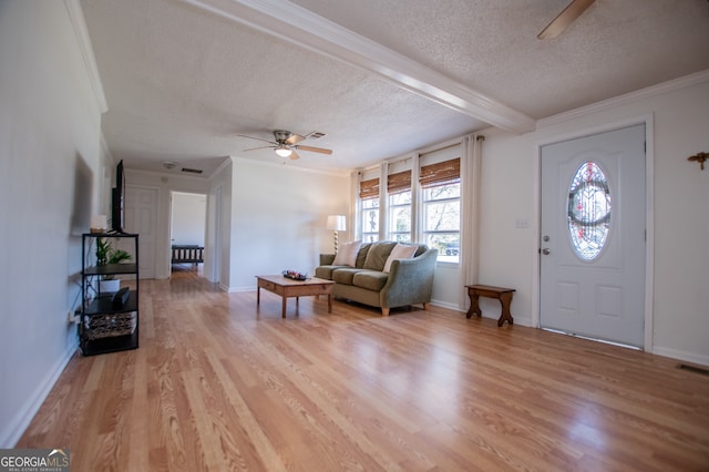 entryway with ceiling fan, light hardwood / wood-style flooring, beamed ceiling, crown molding, and a textured ceiling