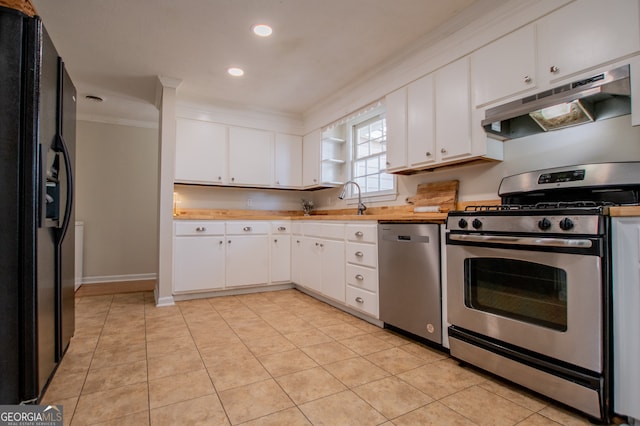 kitchen featuring sink, stainless steel appliances, white cabinets, light tile patterned flooring, and ornamental molding