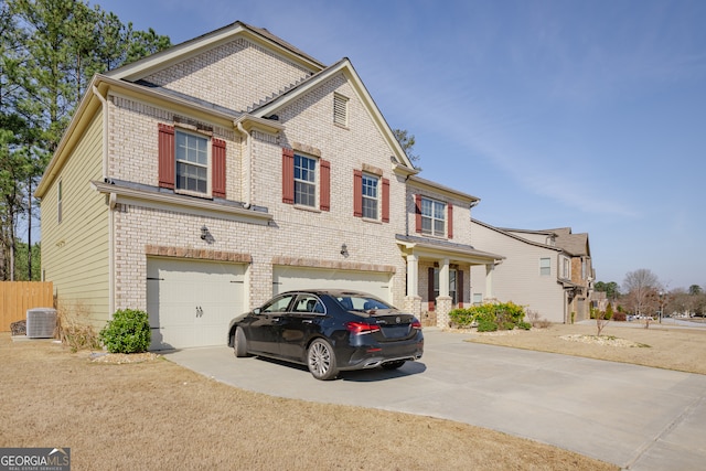 view of front of house featuring a garage and central air condition unit