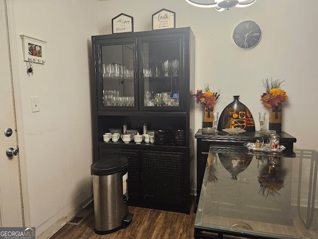 bar featuring dark wood-type flooring