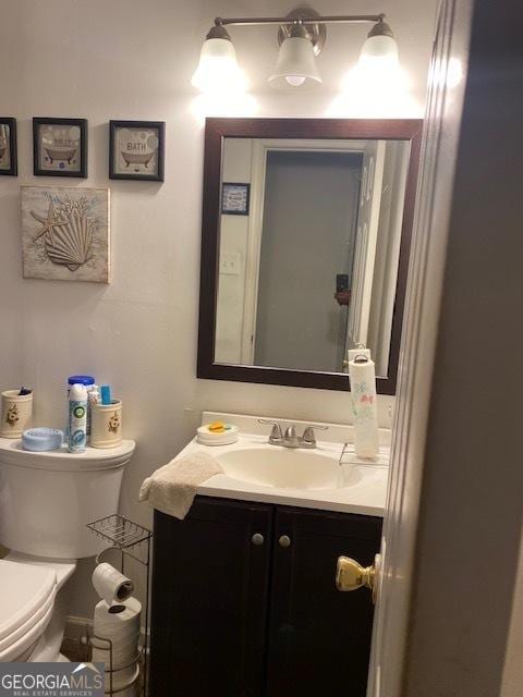 bathroom featuring vanity and toilet