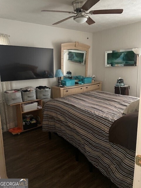 bedroom with ceiling fan and dark hardwood / wood-style floors