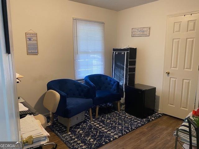 sitting room with dark wood-type flooring