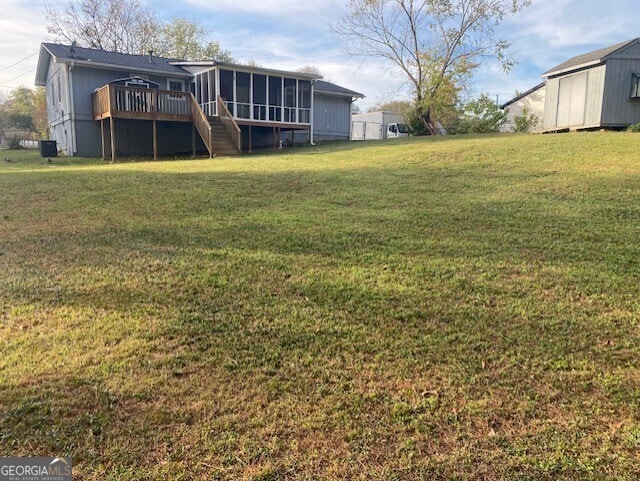 view of yard featuring a shed and a deck