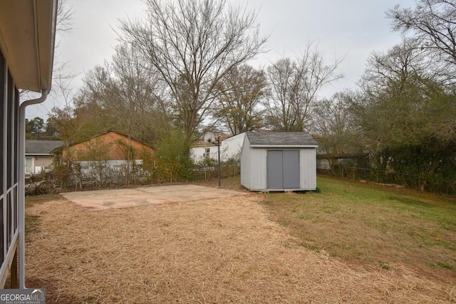 view of yard featuring a storage shed and a patio