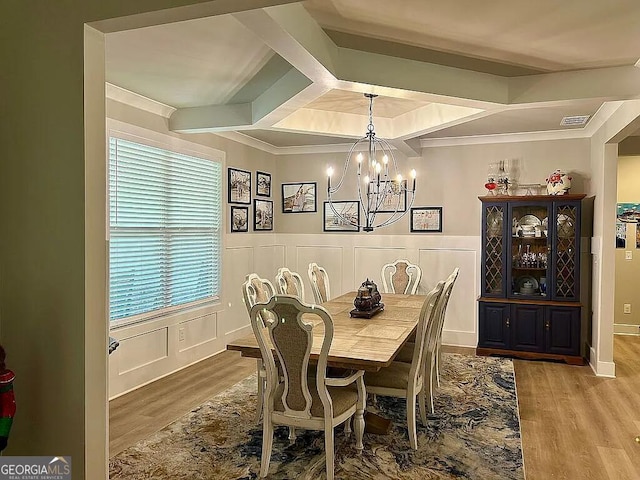 dining room with crown molding, hardwood / wood-style floors, a chandelier, and coffered ceiling