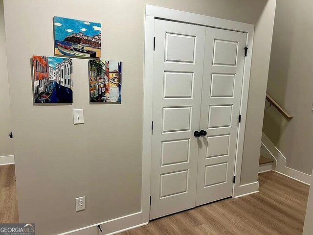 hall with hardwood / wood-style floors