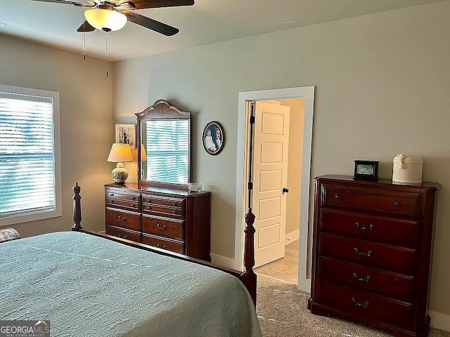 bedroom featuring light carpet and ceiling fan