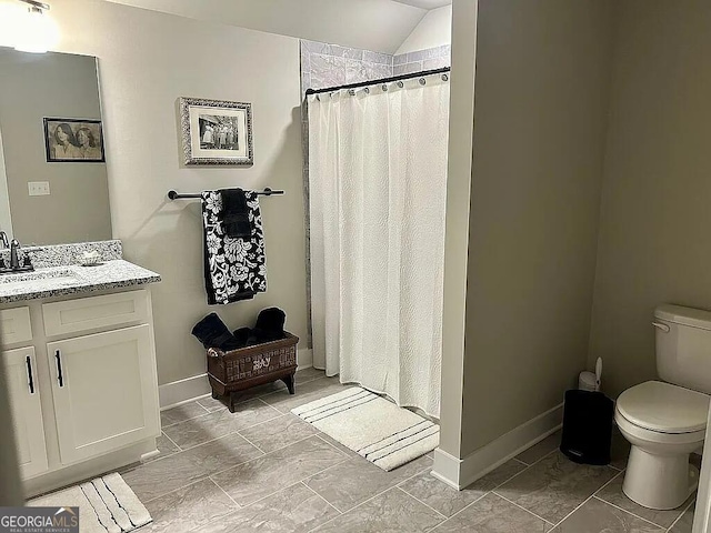 bathroom with toilet, vanity, vaulted ceiling, and walk in shower