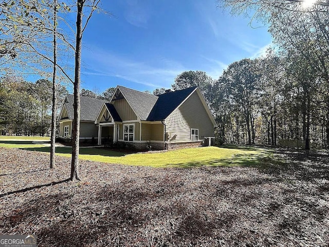 view of side of property with a yard