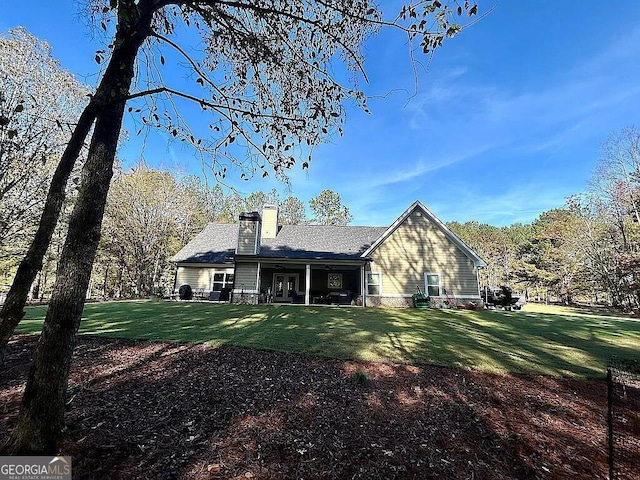 back of house featuring a yard