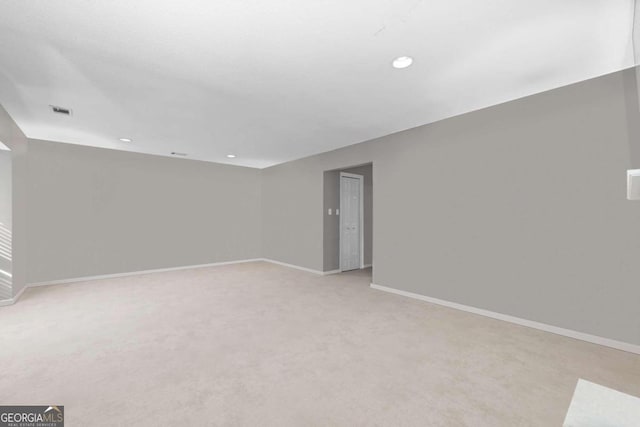 empty room featuring light colored carpet