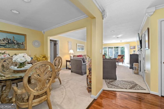 dining area featuring light hardwood / wood-style floors and crown molding