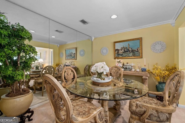 dining space featuring light colored carpet and ornamental molding