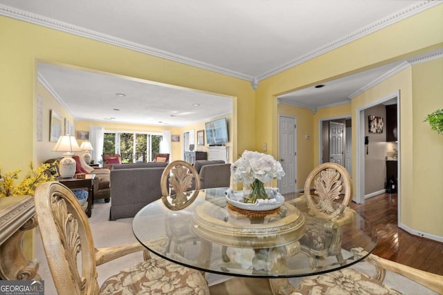 dining area featuring crown molding and hardwood / wood-style floors