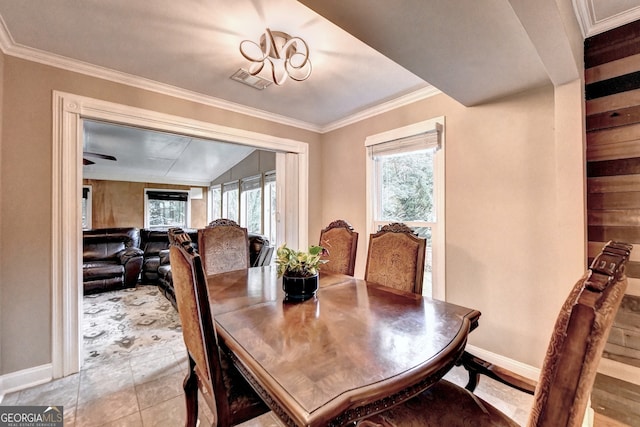 dining space with light tile patterned flooring and ornamental molding