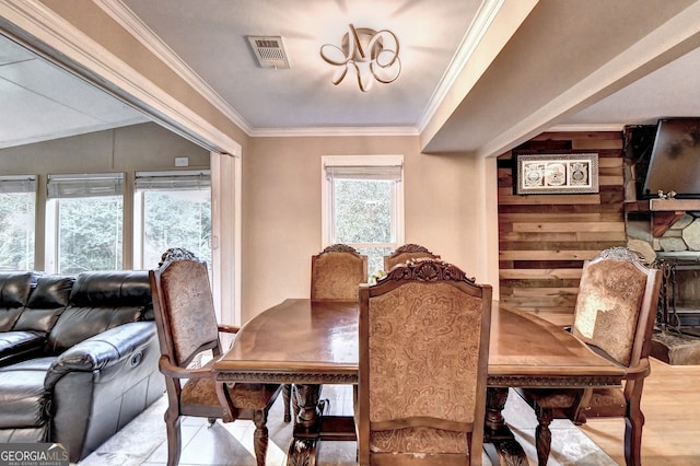 dining area with hardwood / wood-style flooring and ornamental molding