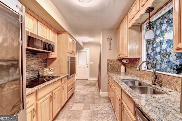 kitchen with backsplash, light brown cabinetry, stainless steel appliances, and sink