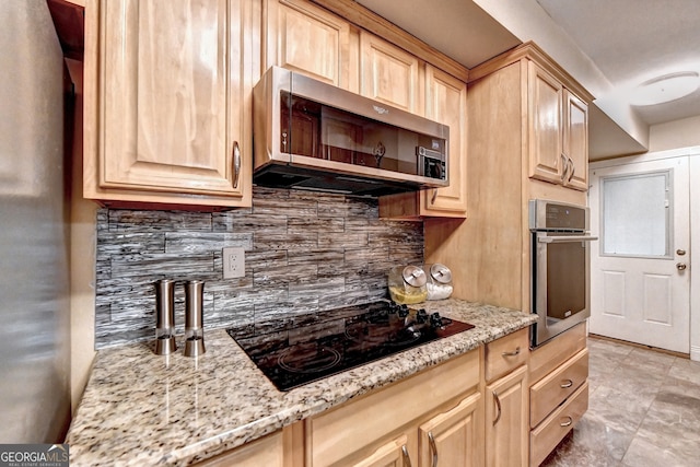 kitchen with backsplash, light stone counters, stainless steel appliances, and light brown cabinetry