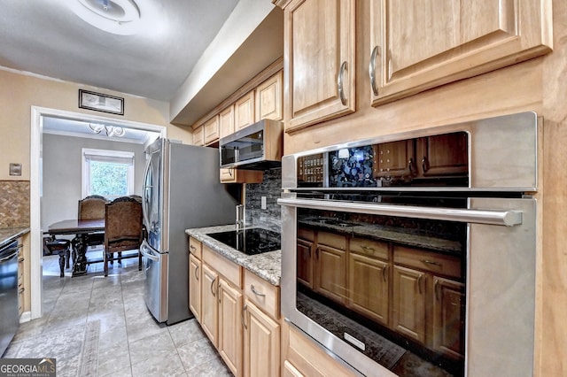 kitchen featuring light stone countertops, appliances with stainless steel finishes, light brown cabinetry, tasteful backsplash, and light tile patterned floors