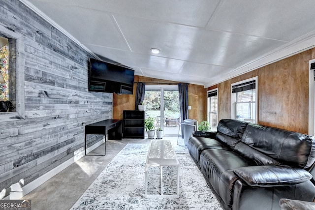 living room featuring vaulted ceiling, crown molding, and wood walls