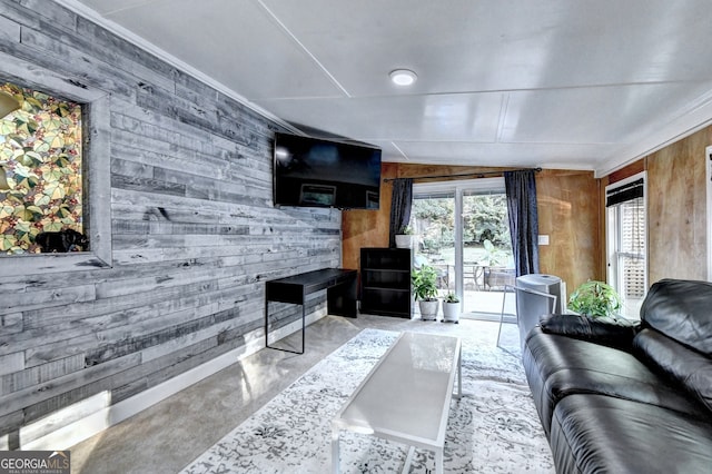 living room with wood walls, lofted ceiling, and crown molding