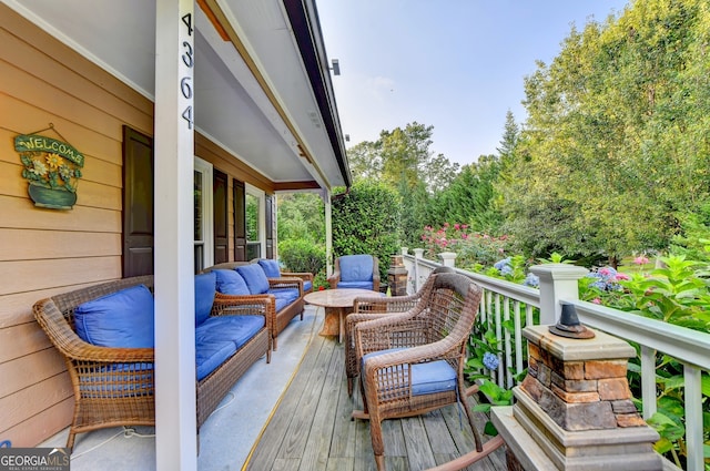 wooden deck with outdoor lounge area