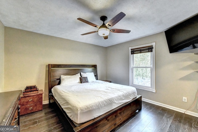 bedroom featuring ceiling fan, dark hardwood / wood-style flooring, and a textured ceiling