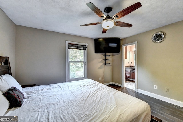 bedroom with a textured ceiling, ceiling fan, dark hardwood / wood-style flooring, and ensuite bathroom