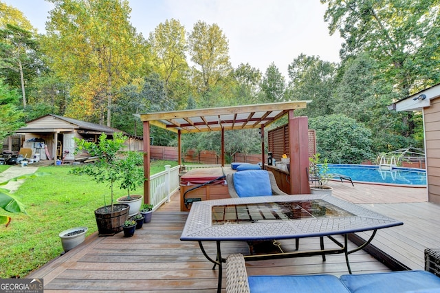 wooden deck featuring a pergola, a yard, and a pool with hot tub