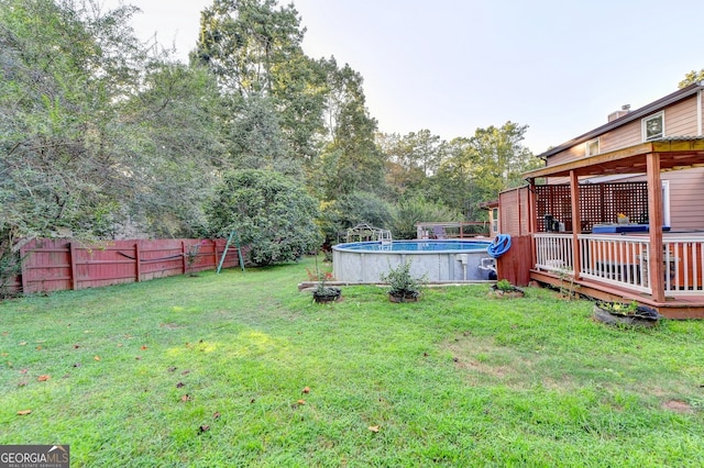 view of yard with a swimming pool side deck