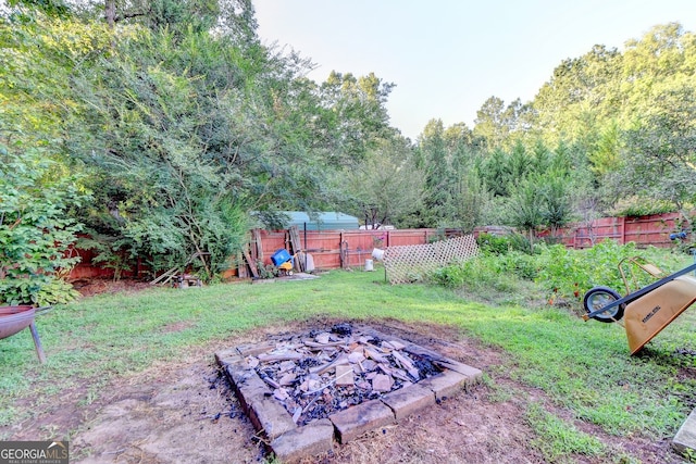 view of yard with an outdoor fire pit