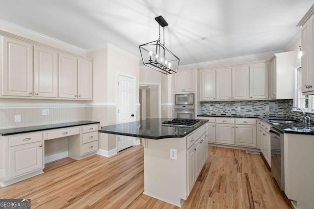 kitchen featuring sink, stainless steel appliances, a kitchen island, light hardwood / wood-style flooring, and white cabinets