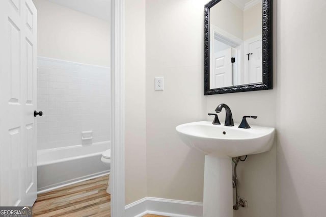 bathroom with hardwood / wood-style flooring and toilet